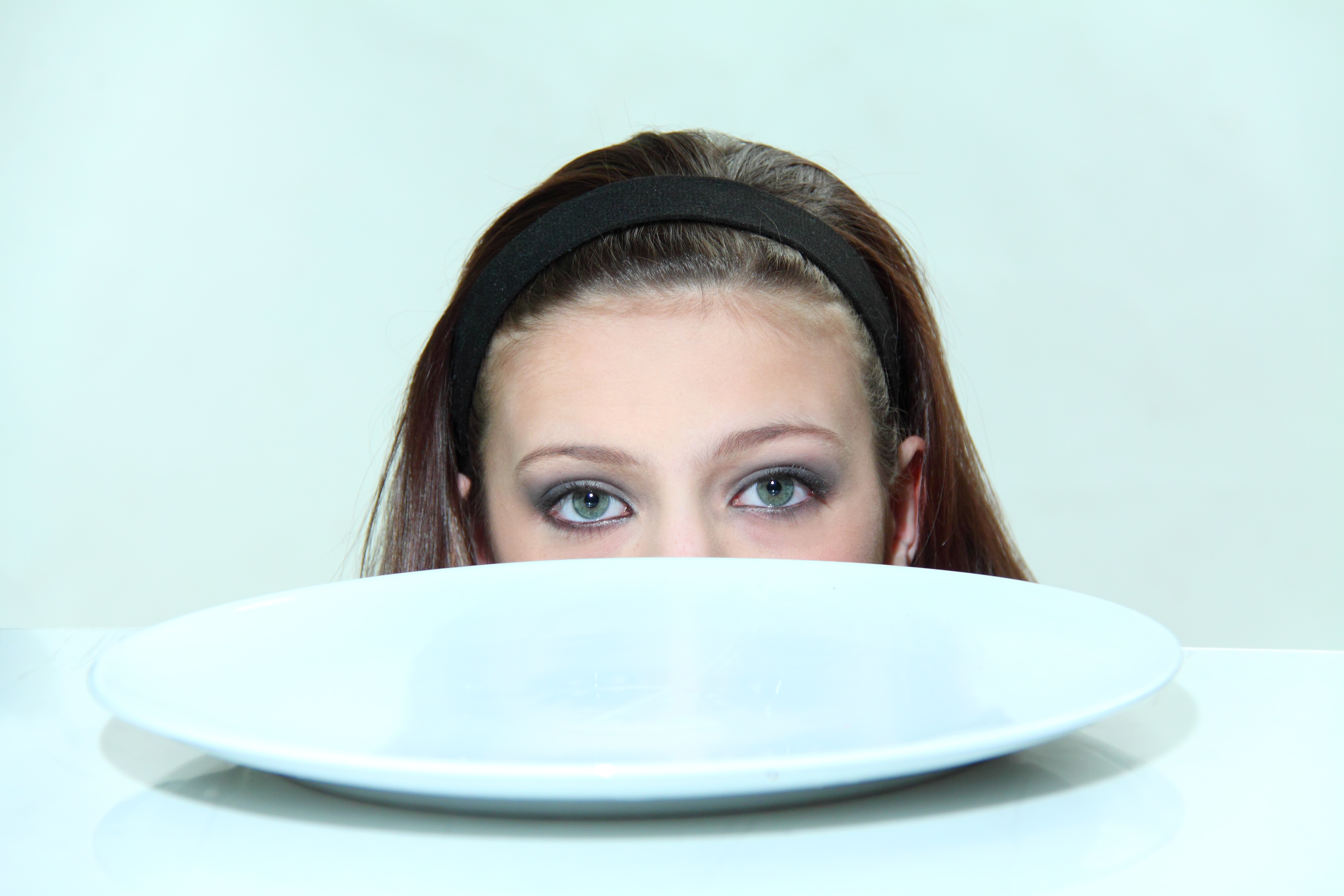 Girl looking at an empty plate nothing is easy when you have an eating disorder